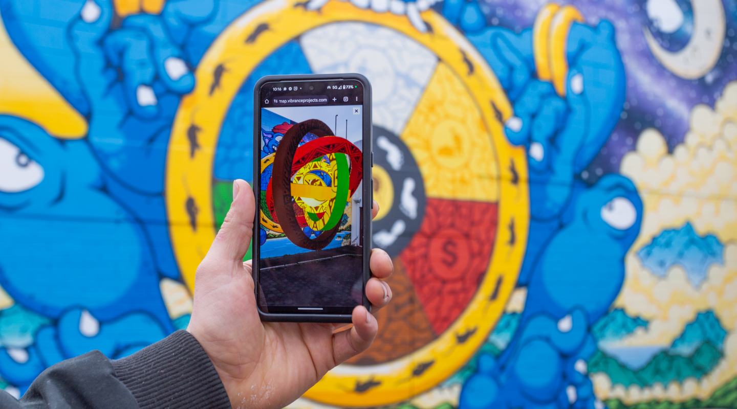 Jasper Kelly in front of his Augmented Reality mural in Sandy Bay.