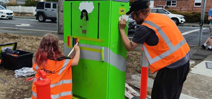 Artist Yolanda Mycak-Machin working on her signal box with guardian
