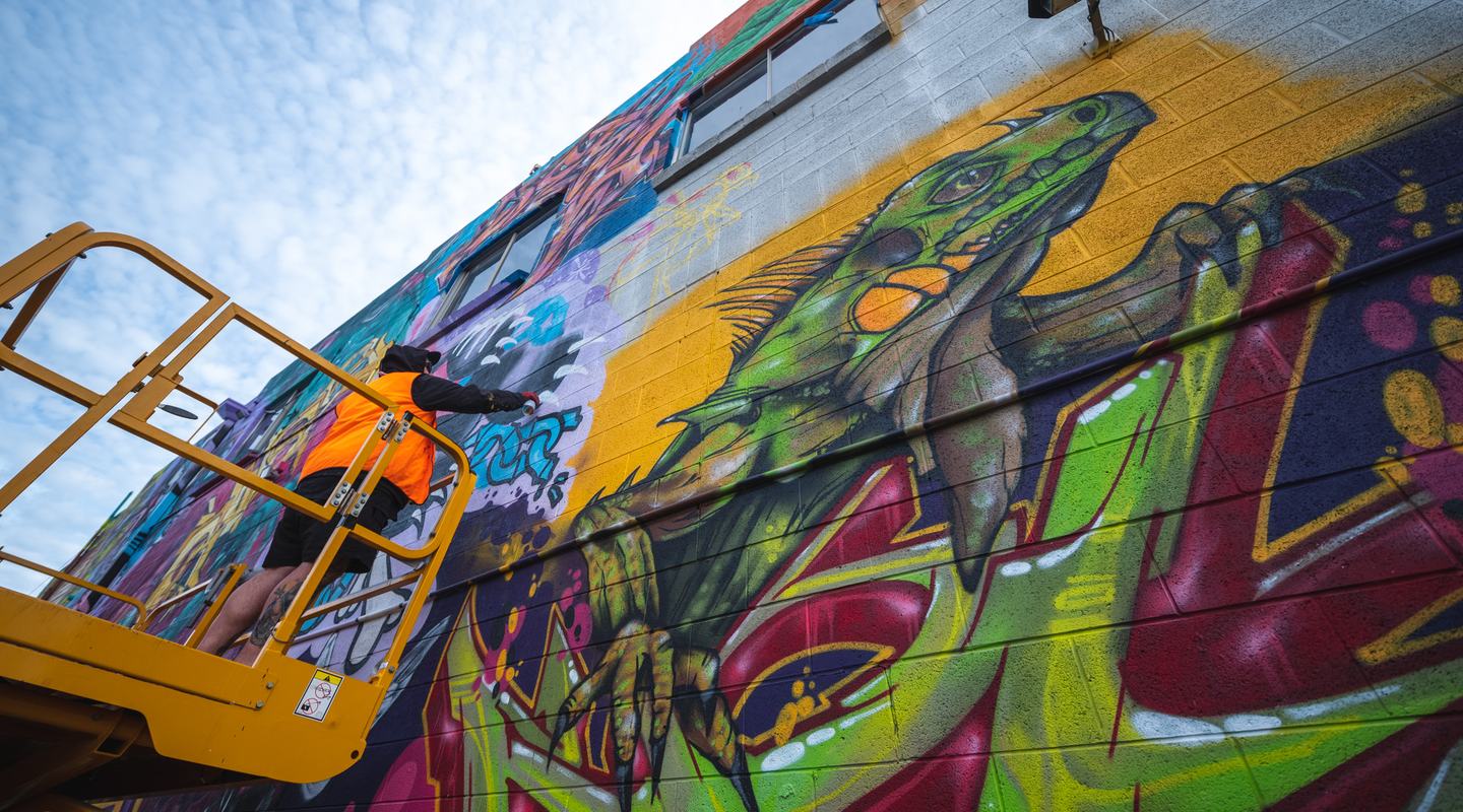 Lukan Smith working on his wall at Vibrance 2021